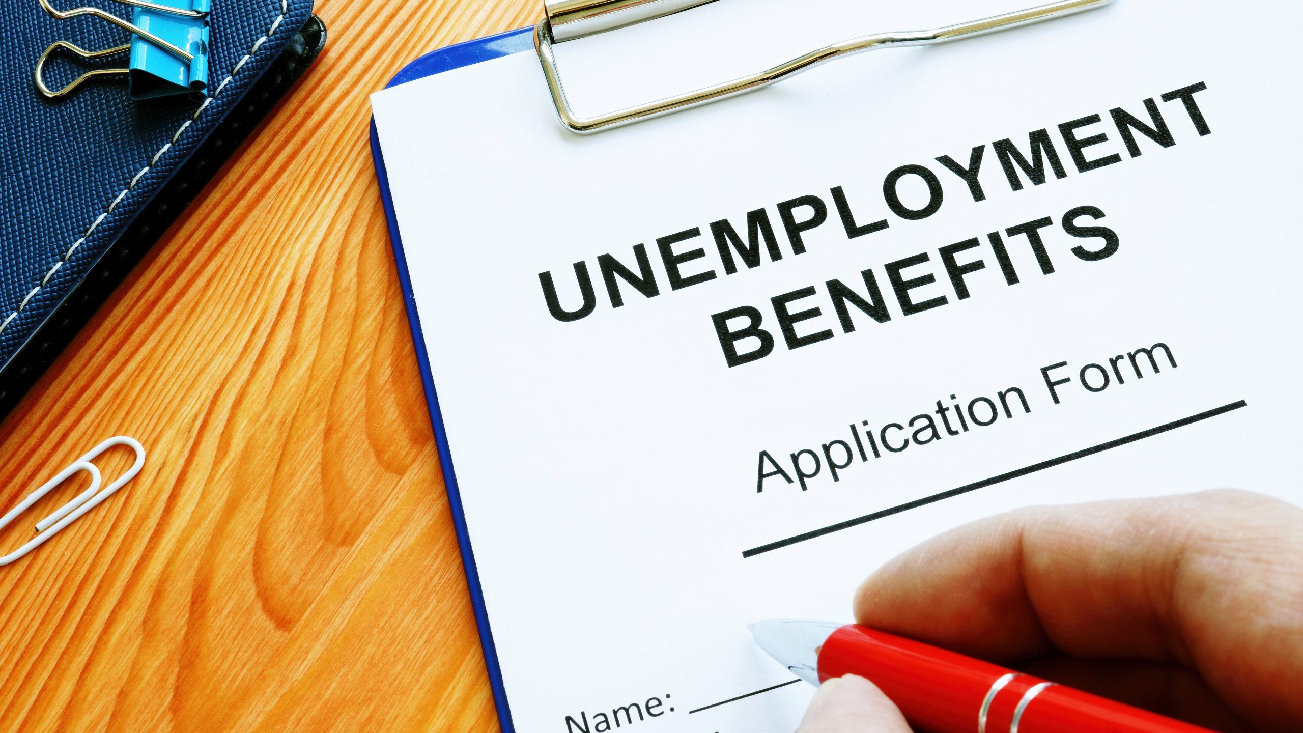 Man fills in Unemployment benefits application form.
