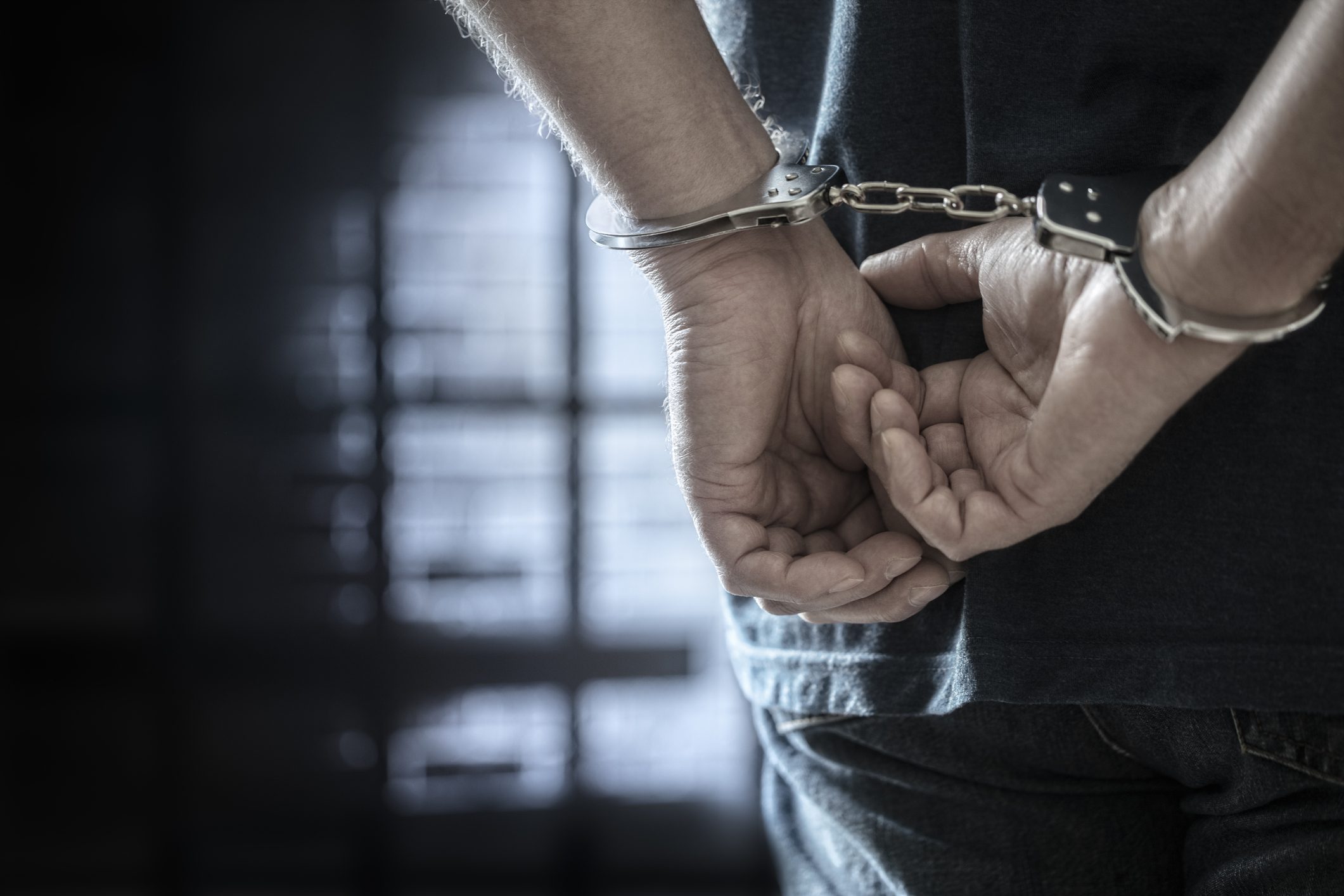 Criminal wearing handcuffs in prison