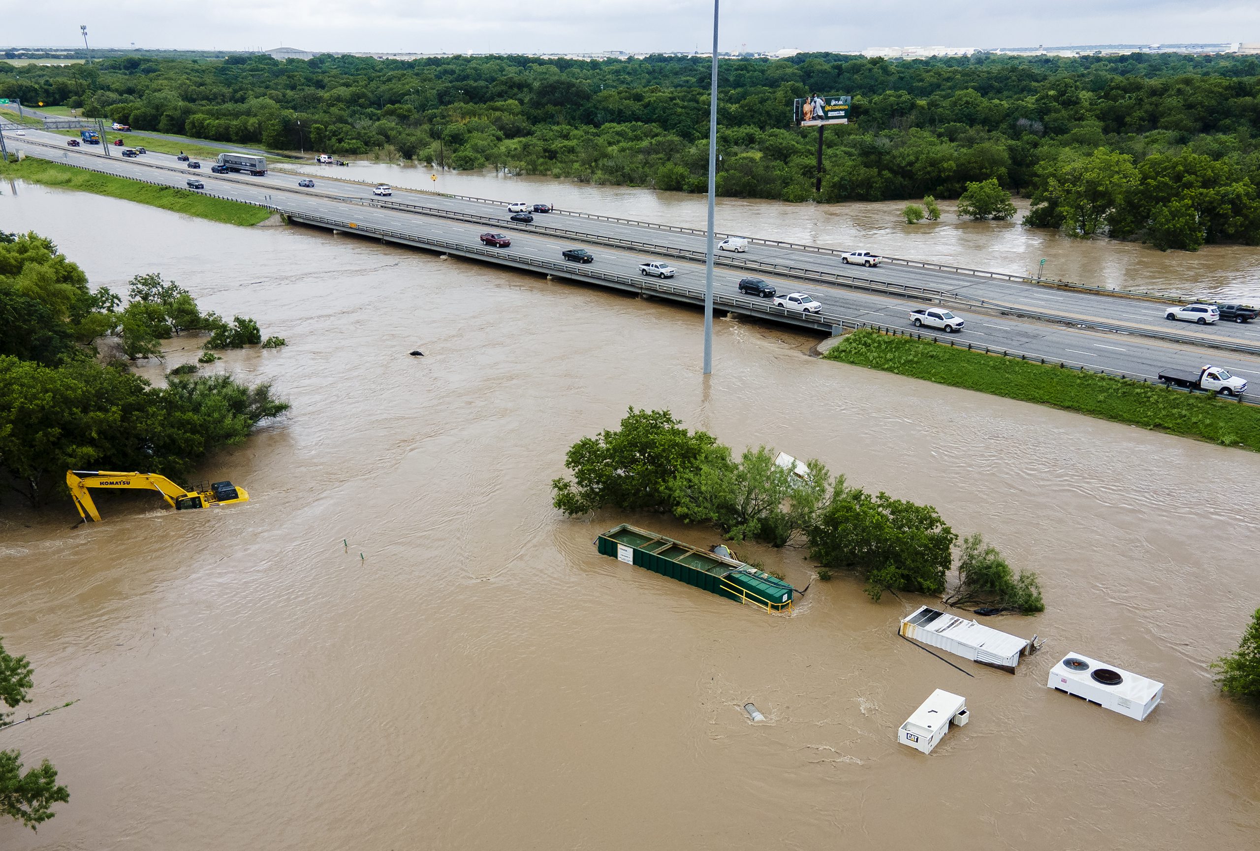 Construction equipment sits in Leon Creek floodwaters near U.S. 90 on Tuesday.