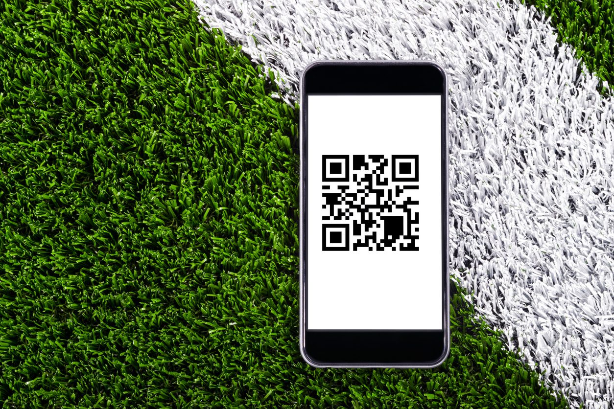 Smart Phone on turf with online Sporting Event tickets