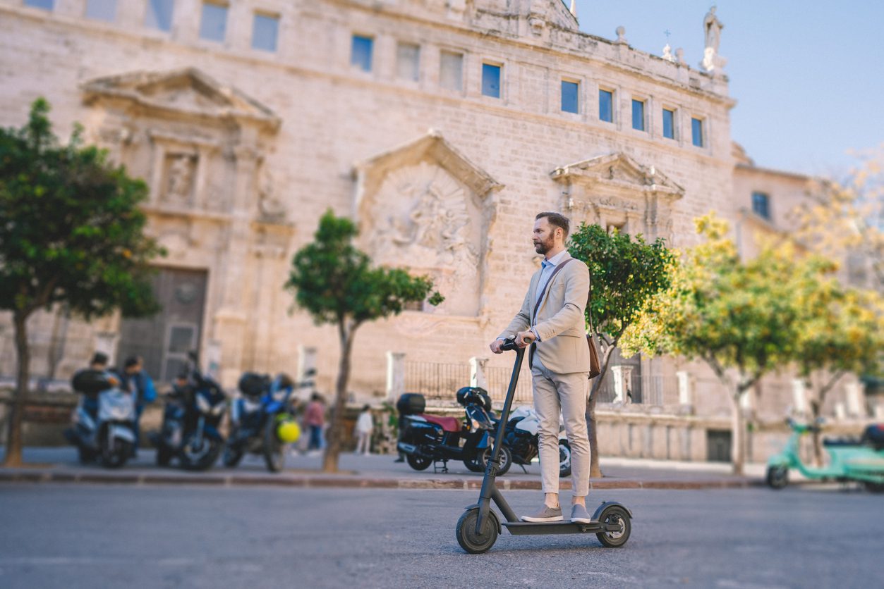 Businessman riding a motor e-scooter in Valencia