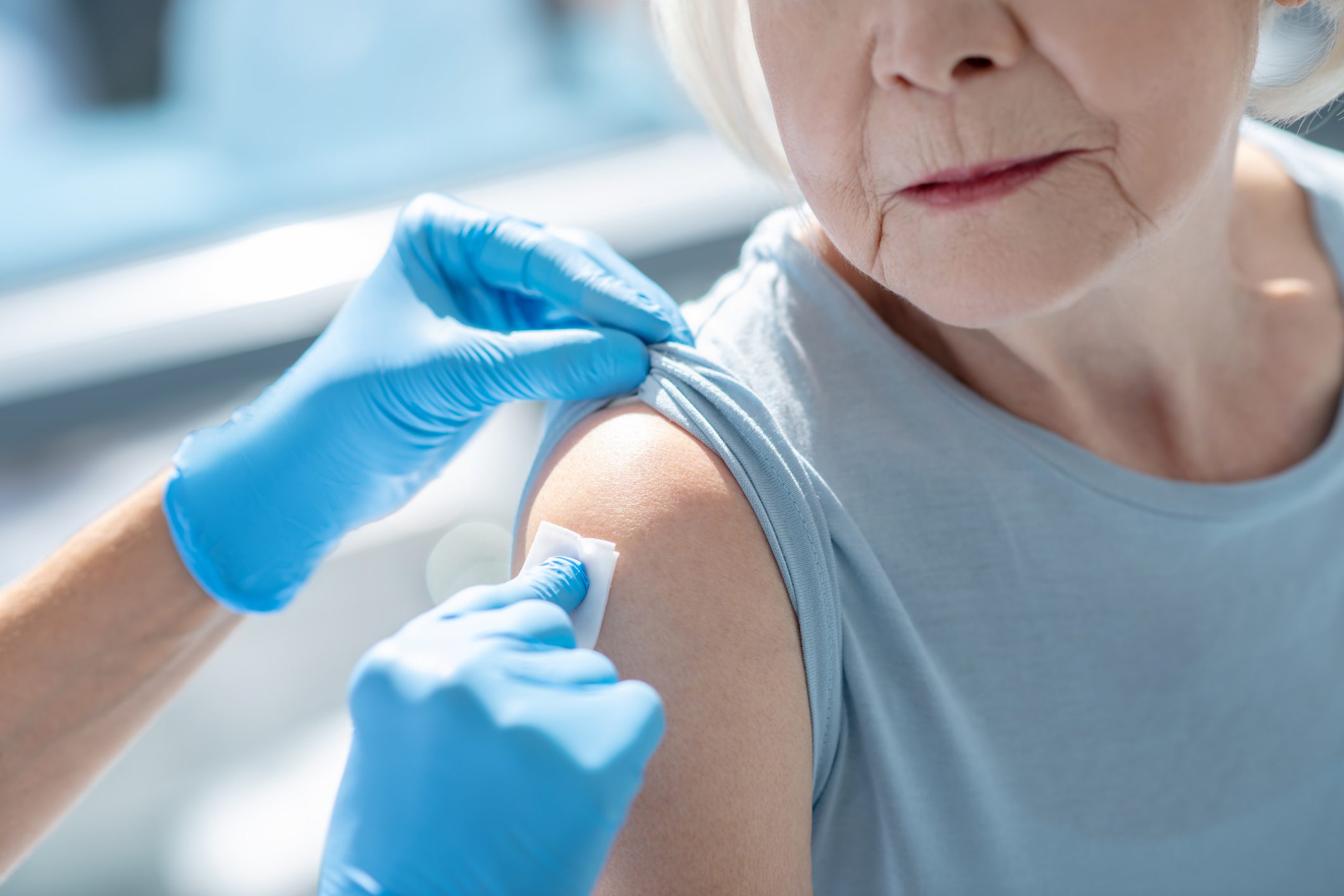 Close up picture of elderly woman having vaccination
