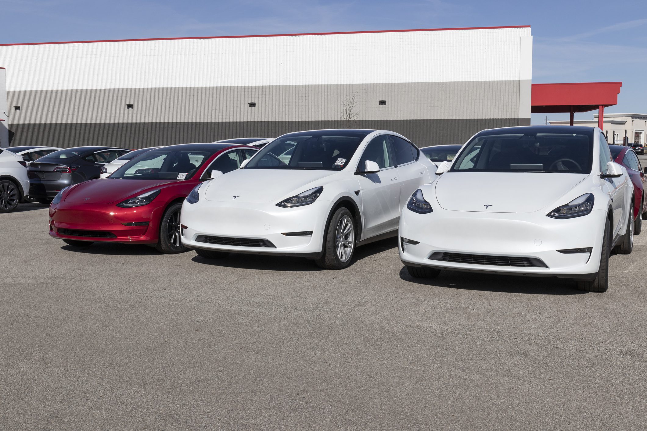 Tesla electric vehicles awaiting preparation for sale. Tesla products include electric cars, battery energy storage and solar panels.