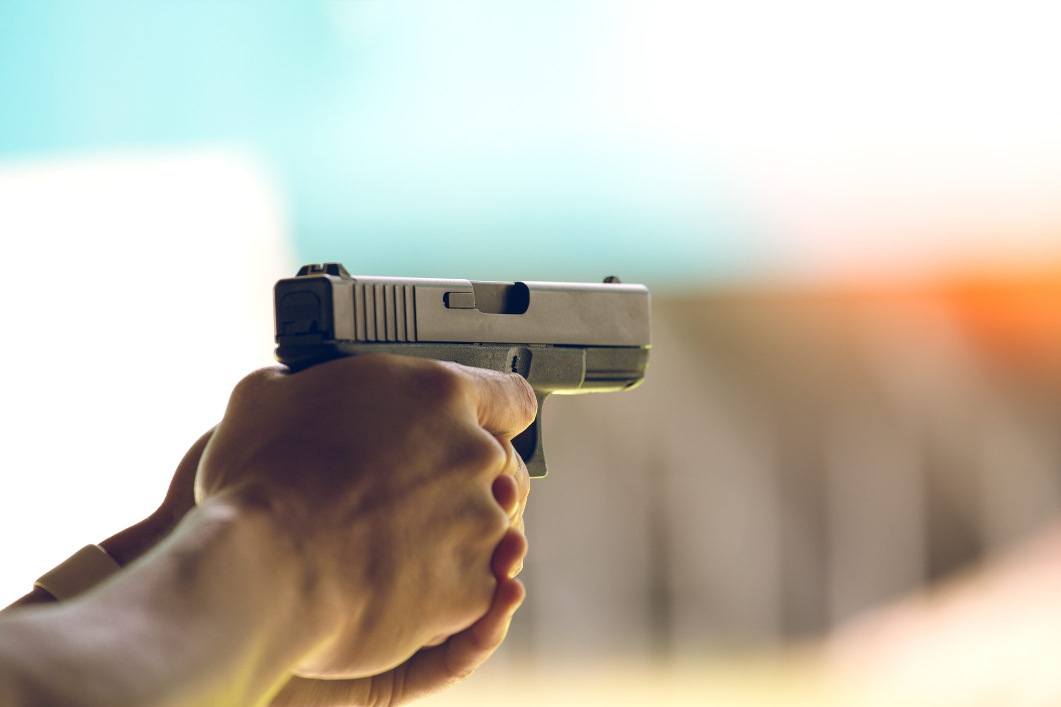 hand aim pistol in academy shooting range