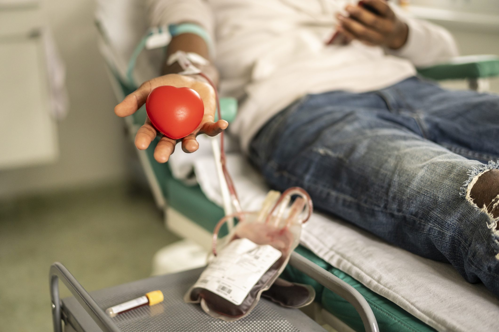 Donor squeezing the heart-shaped ball during blood donation