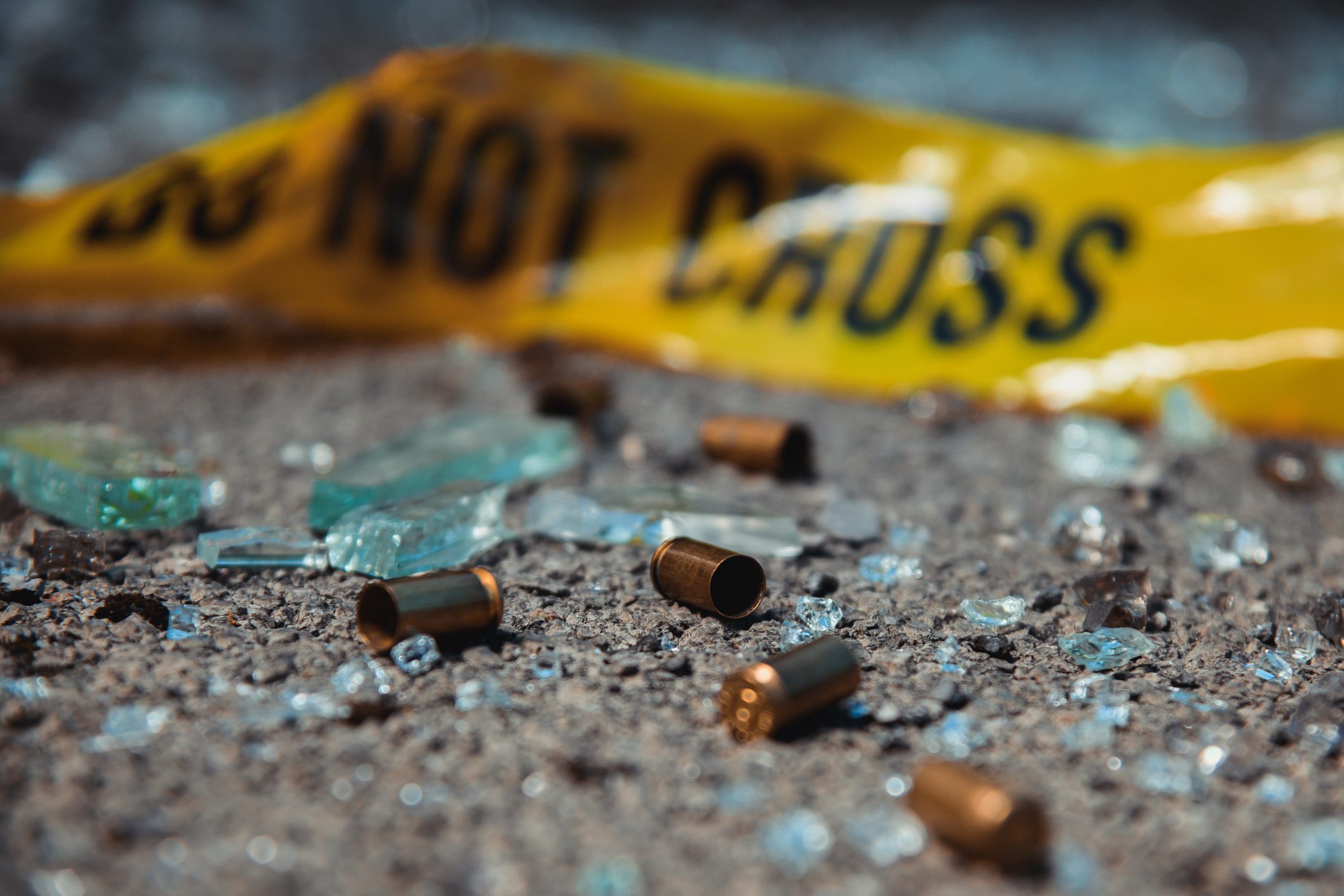 Crime scene with empty bullet shells on ground. | Image by D-Keine