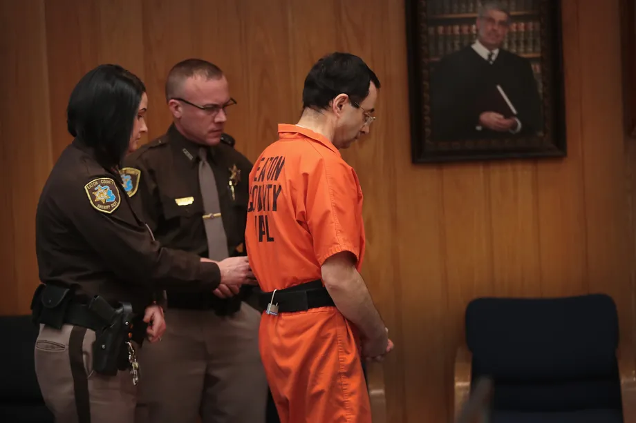 Larry Nassar being escorted during a court hearing. | Image by Scott Olson, Getty Images