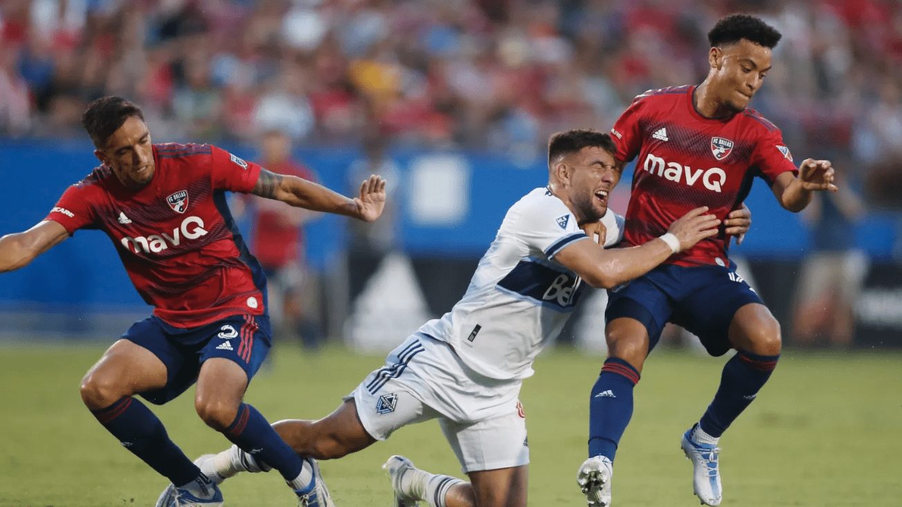 FC Dallas' Jose Martinez and Brandon Servania take down Lucas Cavallini