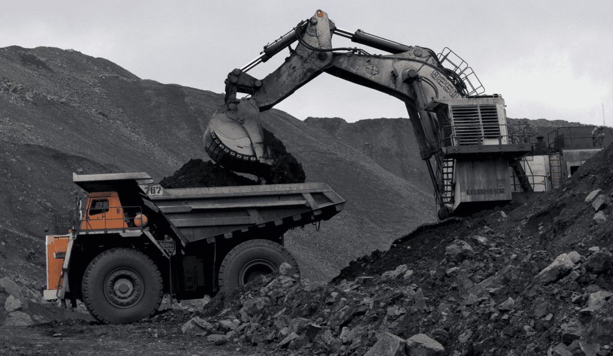 A machine loads a dump-body truck with coal at the Chernigovsky opencast colliery