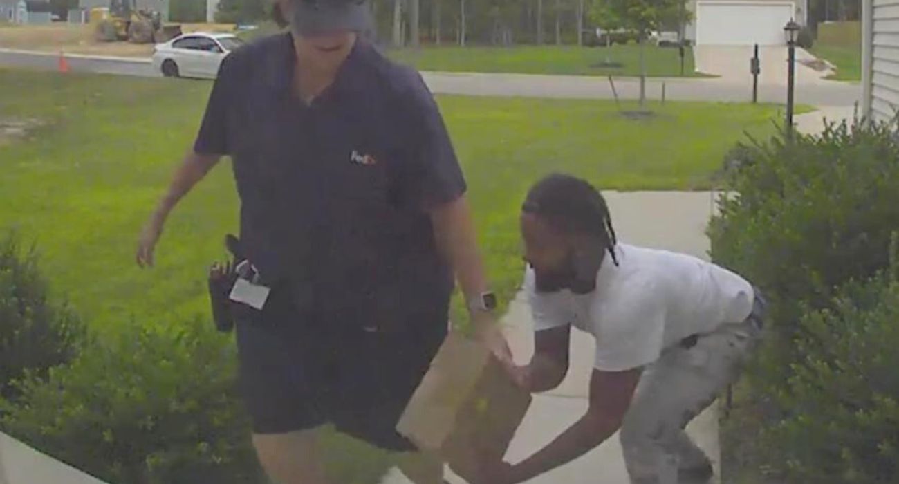 man taking a package out of a delivery drivers hand