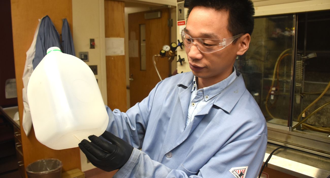 scientist holds water jug