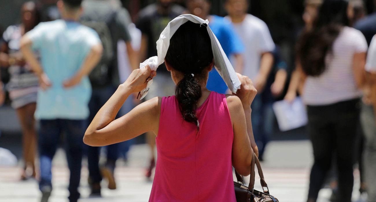 Woman protects her head in extreme heat