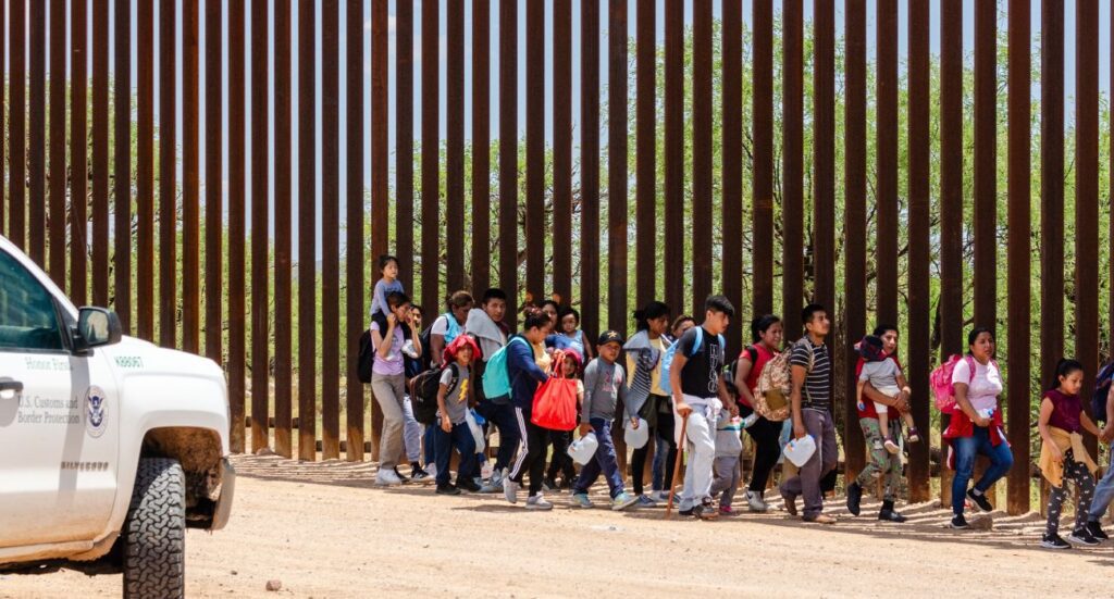 Migrants near the U.S. border wall