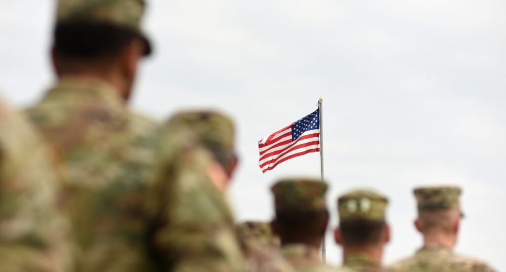 U.S. military members with flag of the United States of America