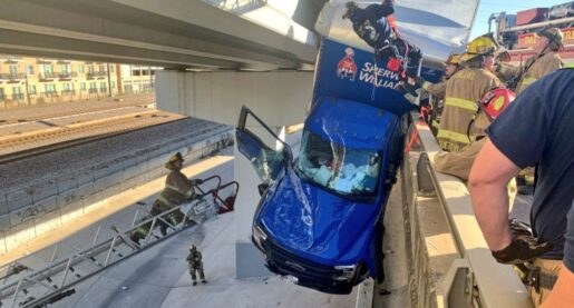 Driver Rescued as Truck Dangles From Overpass