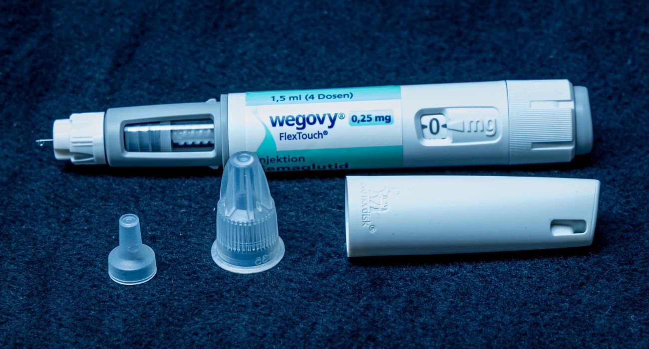 Wegovy self injection pen with one-time needle and protective caps.