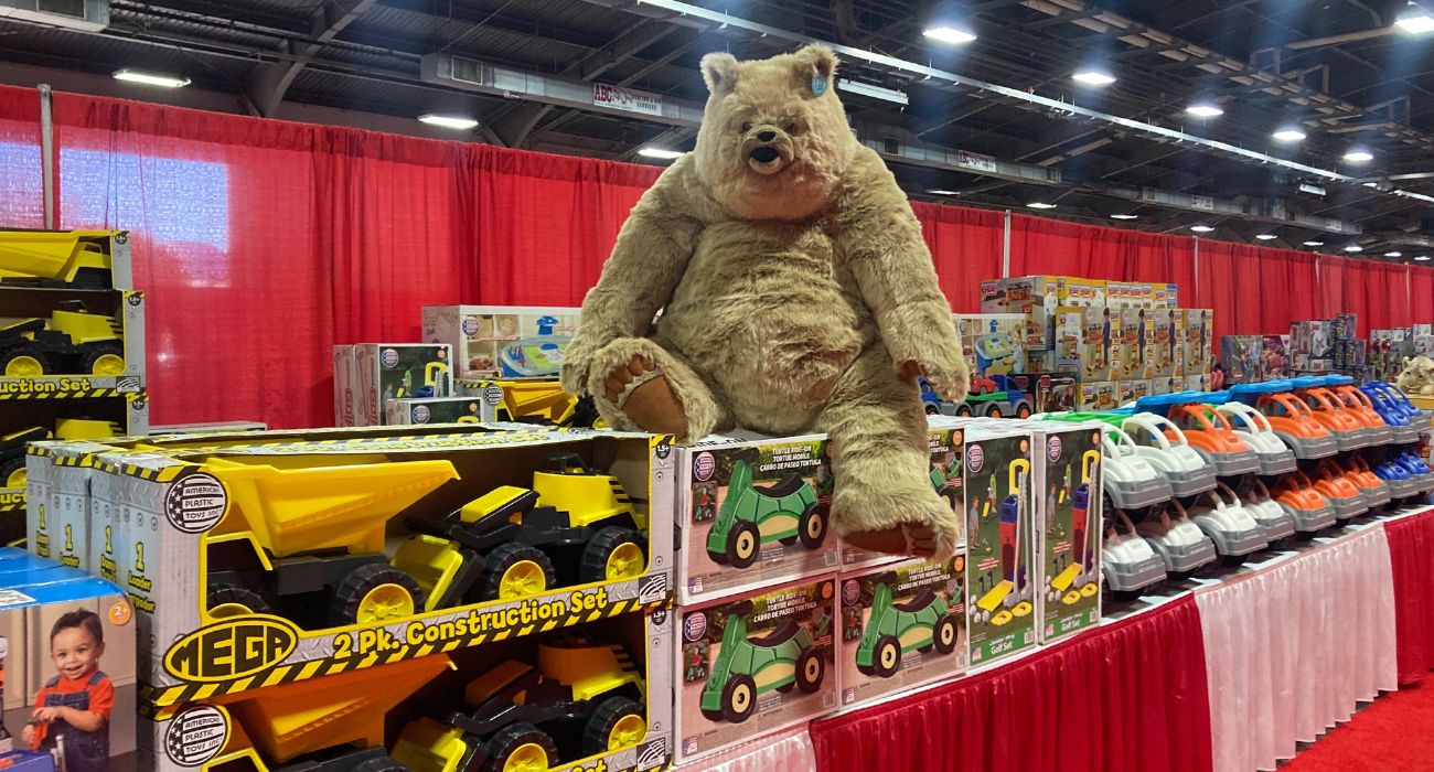 A bear sits on toys at Christmas in the Park