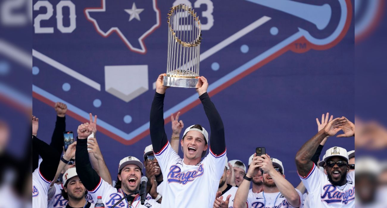 Corey Seager #5 of the Texas Rangers lifts the Commissioner's Trophy
