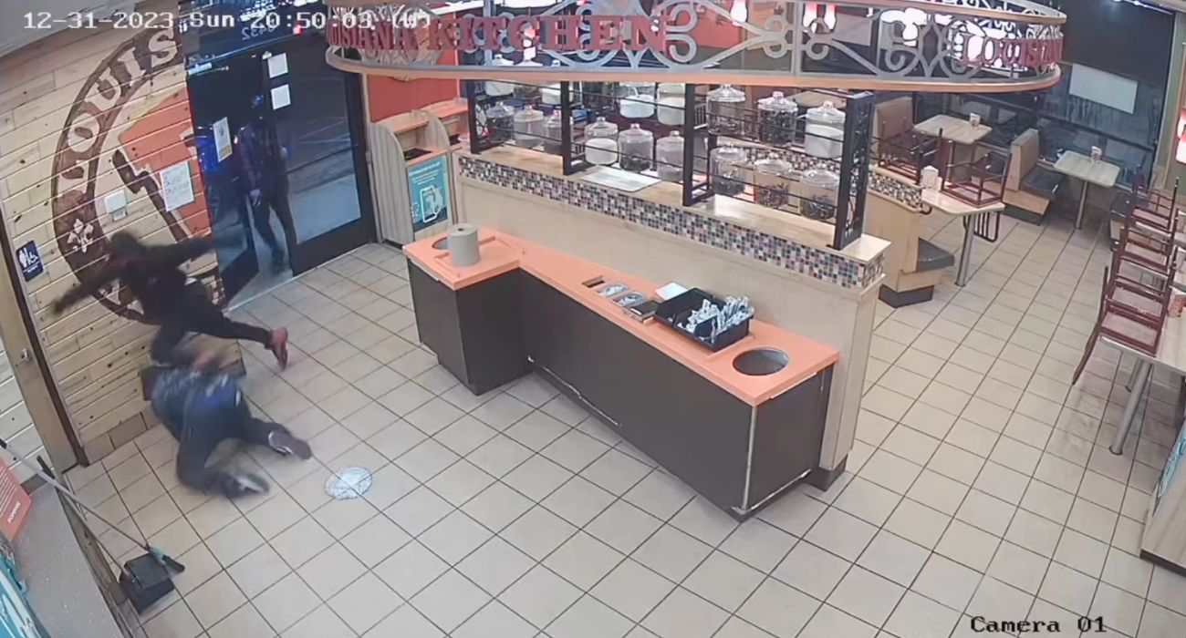Screengrab of surveillance of suspects falling after entering restaurant.