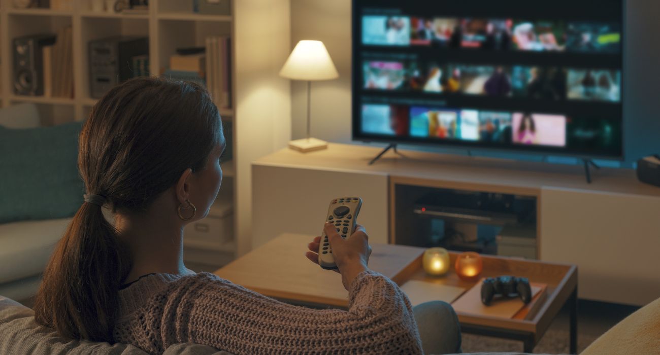 Woman looking through options on television