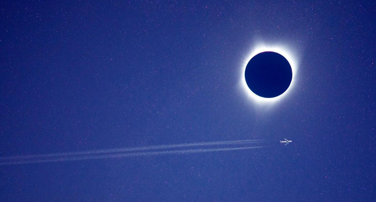 Airplane flying by solar eclipse