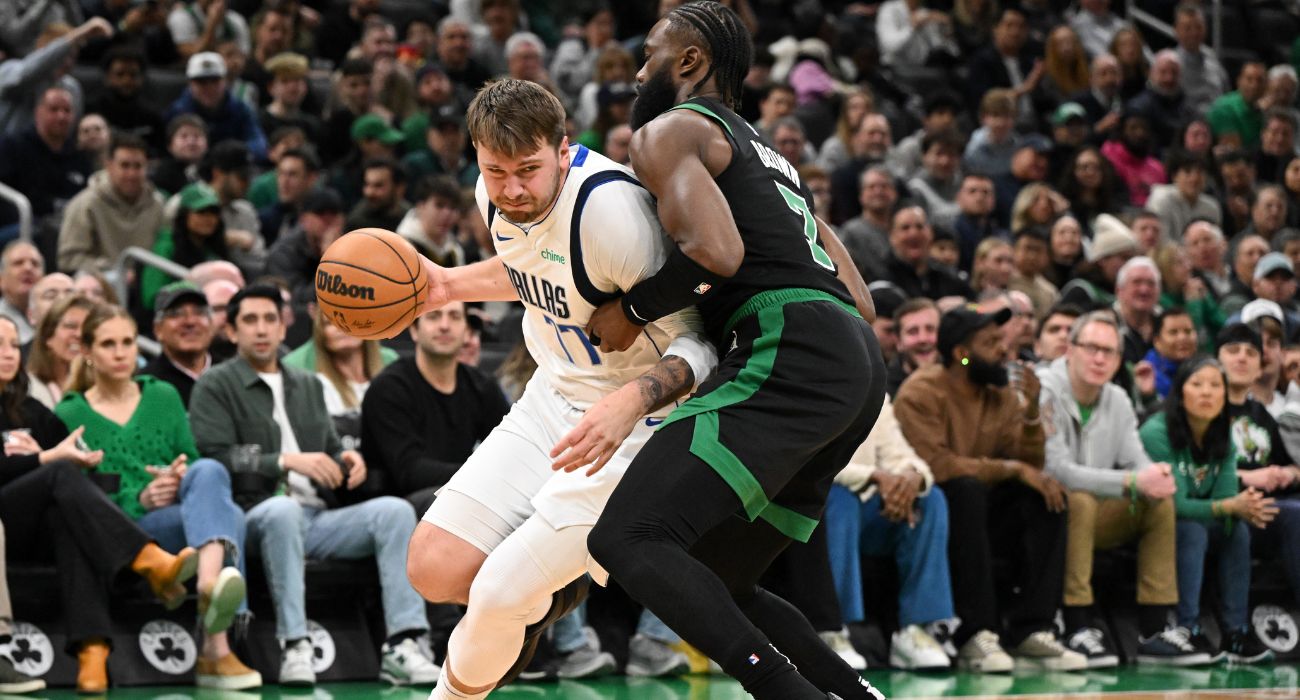 Luka Doncic #77 of the Dallas Mavericks drives to the basket against Jaylen Brown #7 of the Boston Celtics
