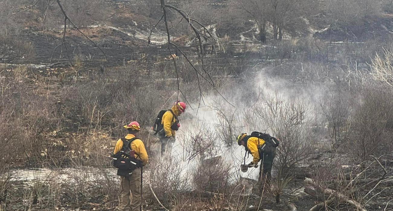 Firefighters work to put out hot spots