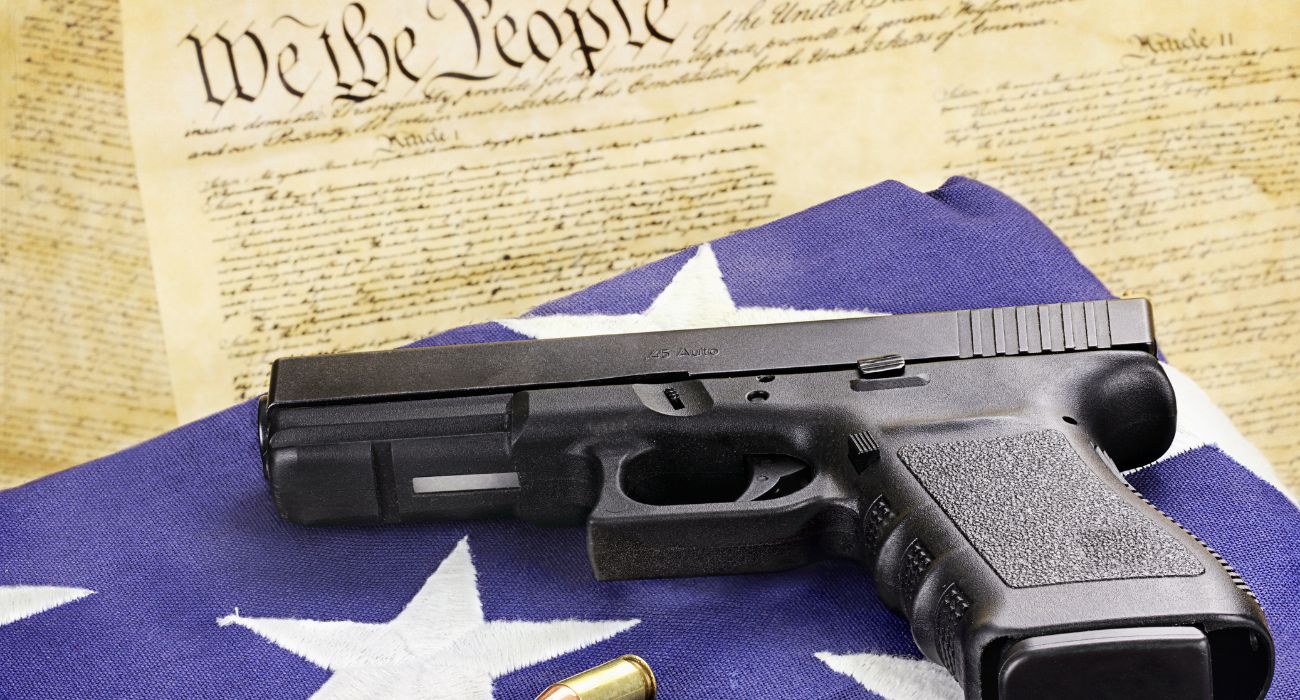 Handgun with ammo on U.S. Constitution