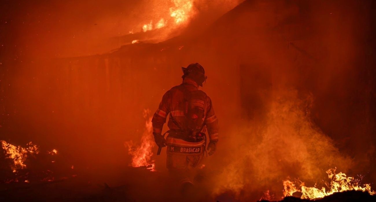 Fort Worth firefighter walks through a blaze.