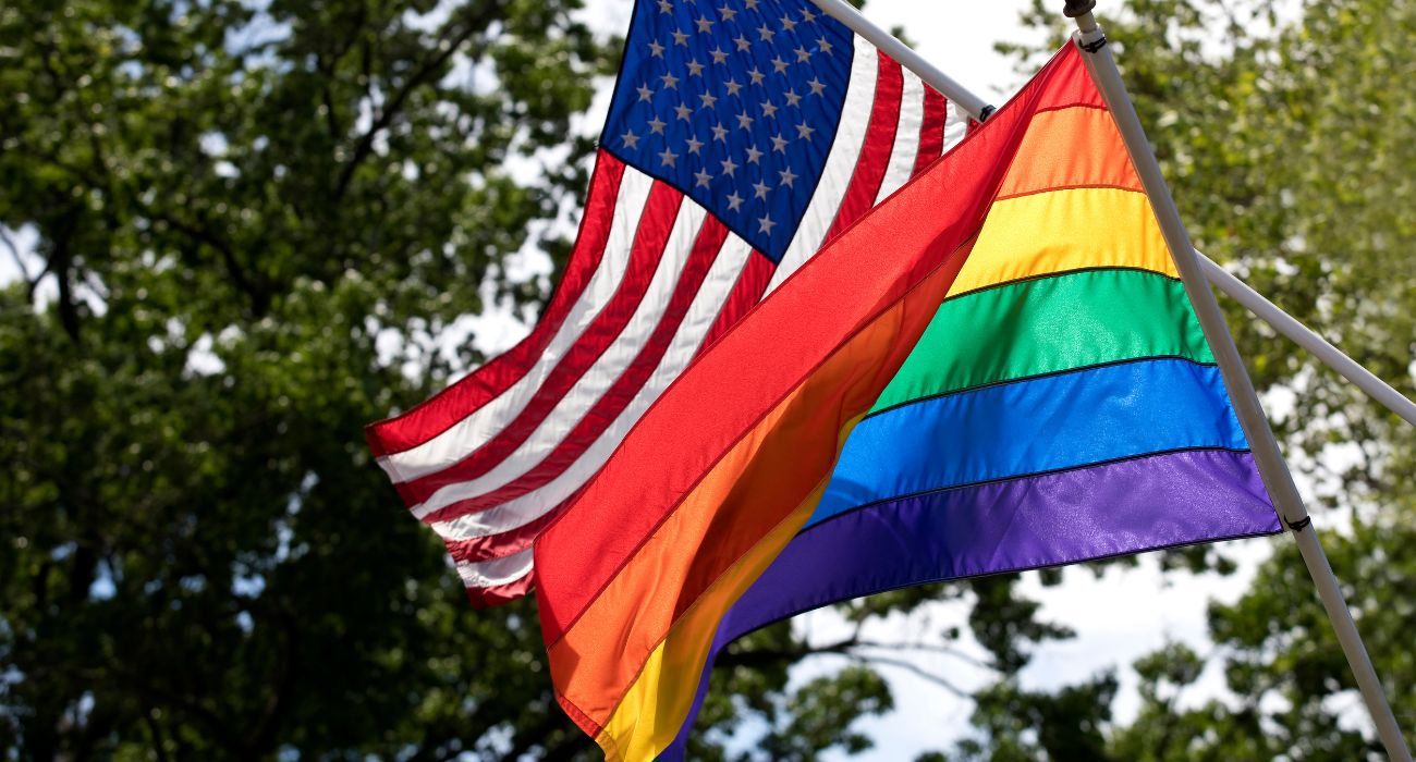 American flag flies with an LGBTQ Pride Flag