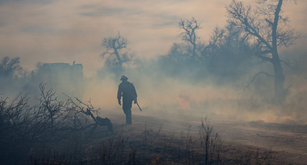 Firefighter walks in smoke