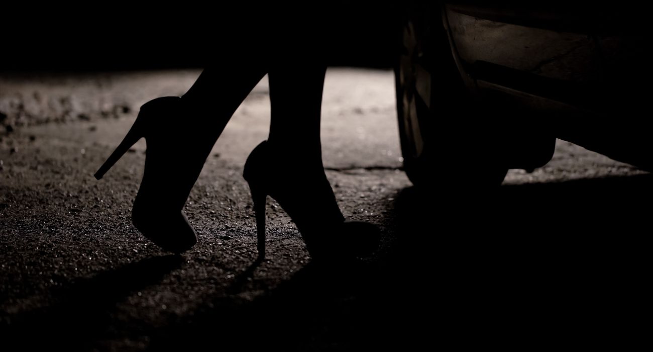 Woman in heels next to car