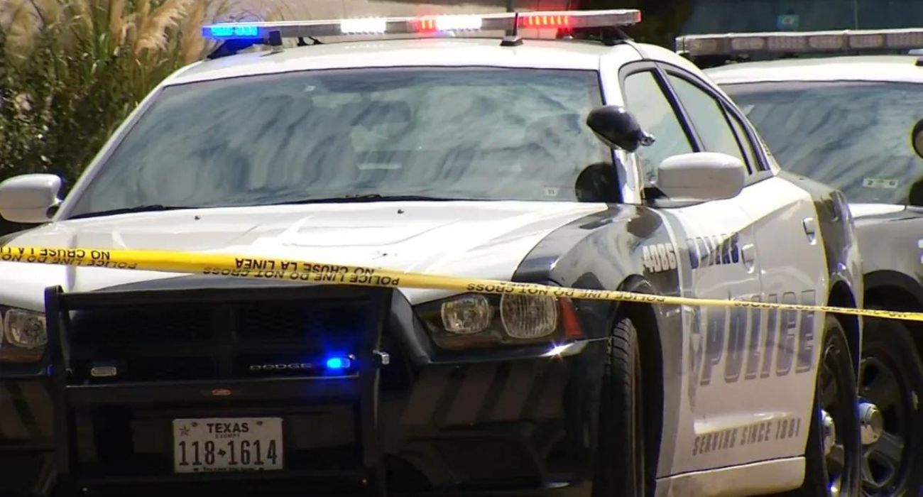 Dallas police unit behind crime scene tape