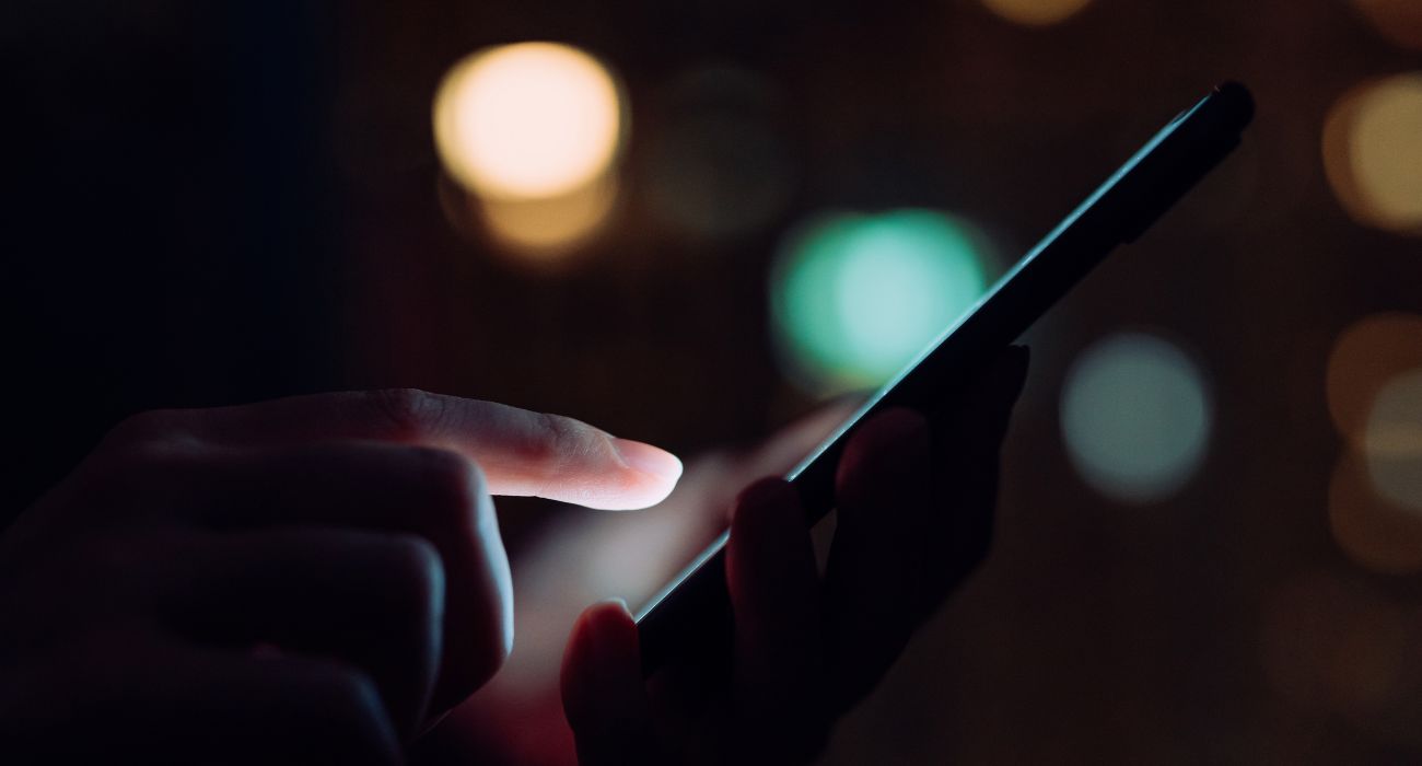 Woman using smartphone in the dark