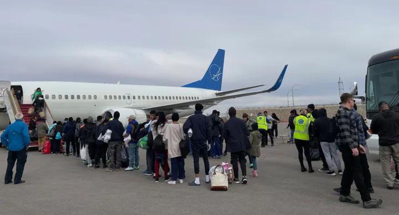 Unlawful migrants board plane bound for Chicago.