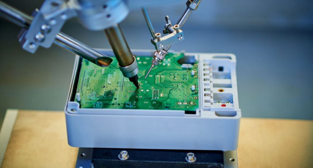 Robotic arm welding and installing component at semiconductor circuit board