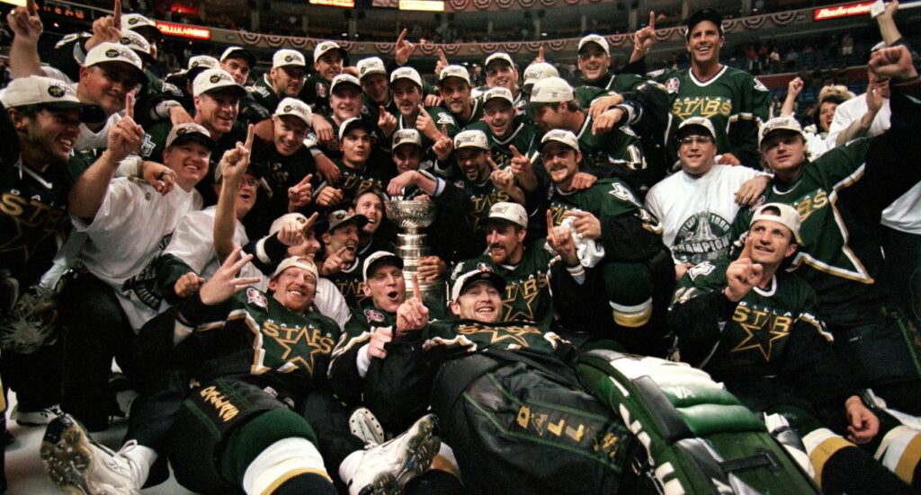 The Dallas Stars pose for a team photo with the Stanley Cup trophy