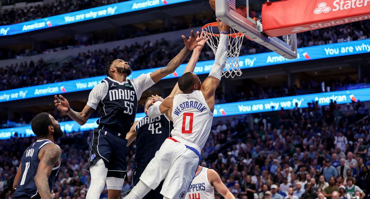 Russell Westbrook #0 of the Los Angeles Clippers goes up for a lay up while defended by Derrick Jones Jr. #55 of the Dallas Mavericks and Maxi Kleber #42