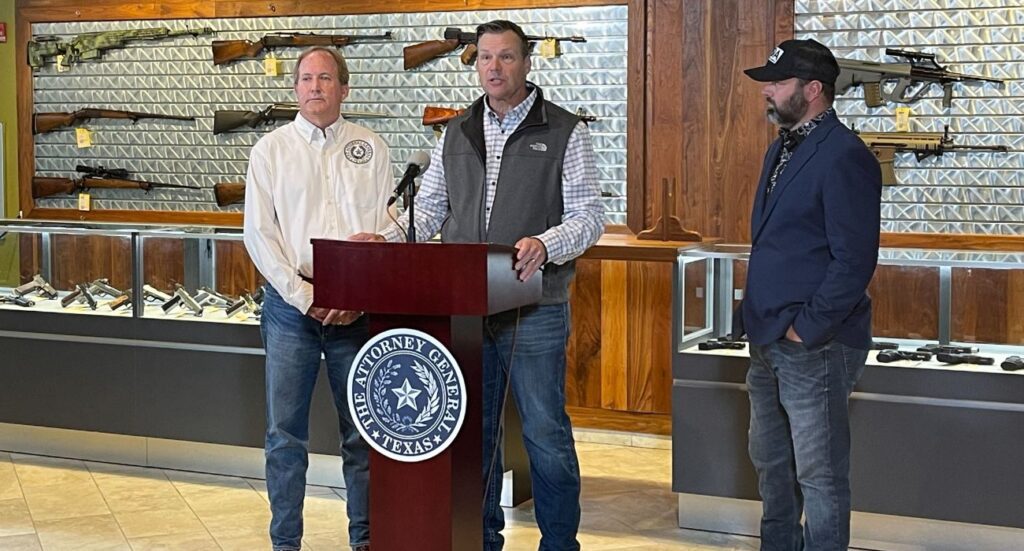 Kansas Attorney General Chris Kobach speaks at a press conference with Texas Attorney General Ken Paxton and Texas Director of Gun Owner of America Wes Virdell