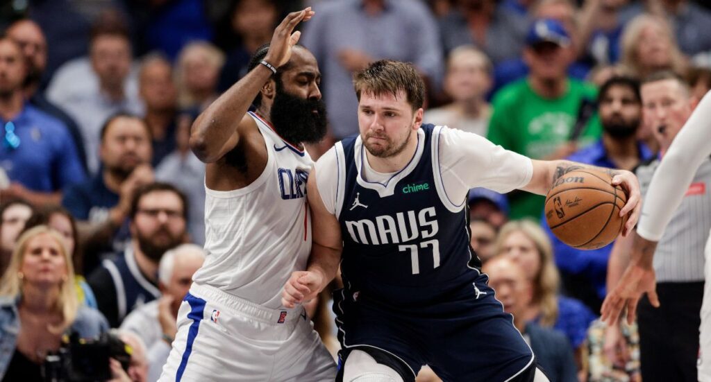 Luka Doncic #77 of the Dallas Mavericks drives to the basket while defended by James Harden #1 of the Los Angeles Clippers
