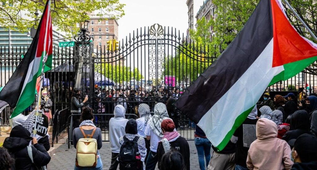 Student pro-Palestinian protesters chant near an entrance to Columbia University.