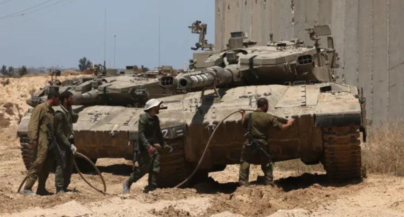 Israeli army tanks take position in southern Israel near the border with the Gaza Strip on May 7, 2024. | Image by Menahem Kahana/AFP via Getty Images