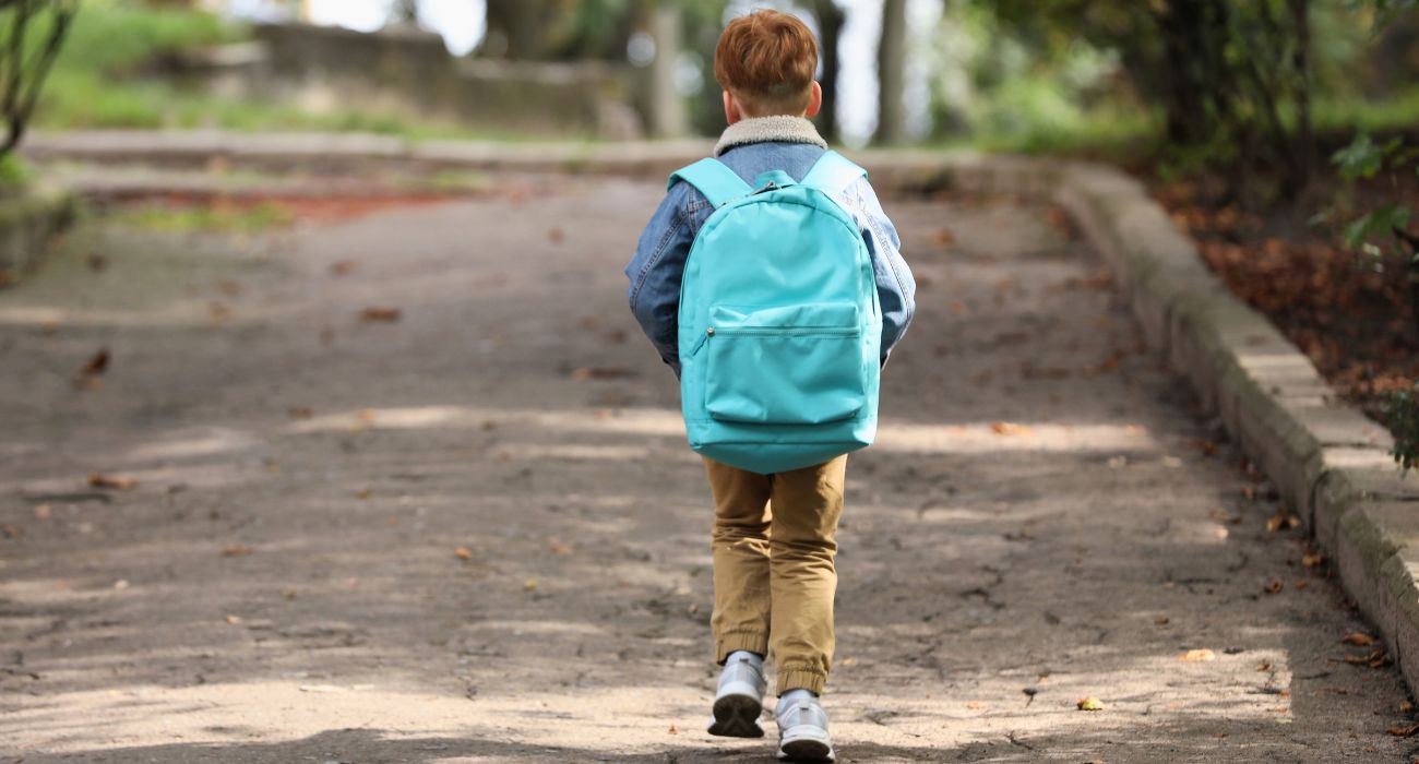 Child walking with backpack