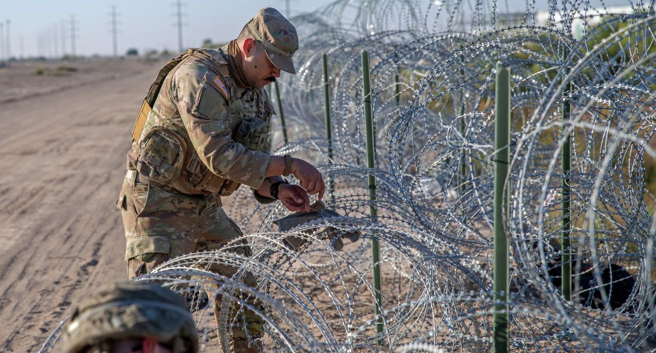 Texas National Guard soldiers repair razor wire barriers at the southern border near El Paso. | Image by Greg Abbott/Facebook
