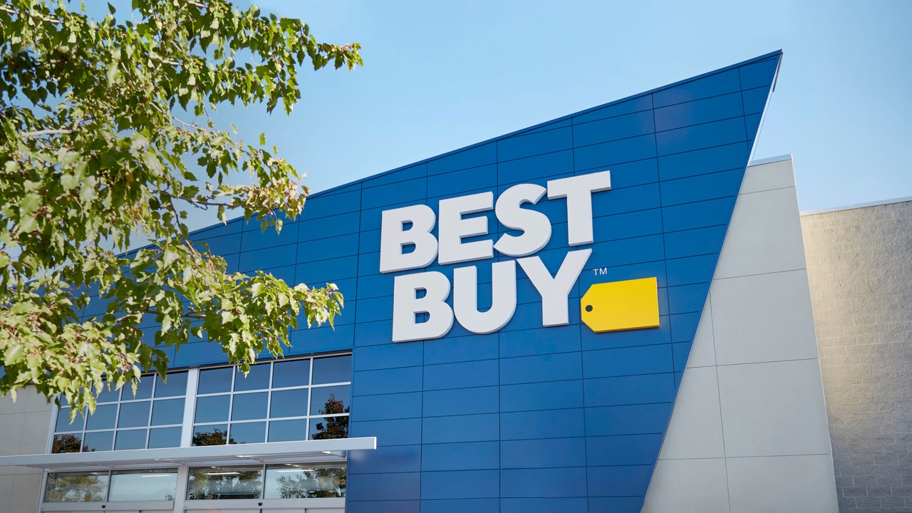 Best Buy storefront with blue exterior panels, white lettering and a yellow price-tag logo.